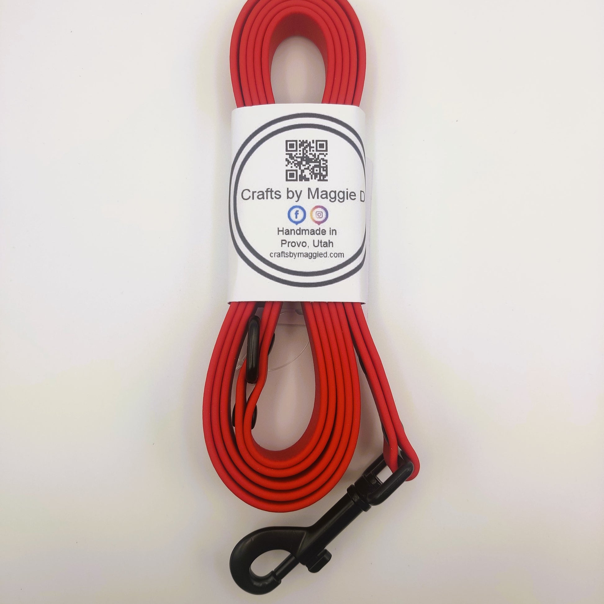 Red BioThane dog leash with black hardware